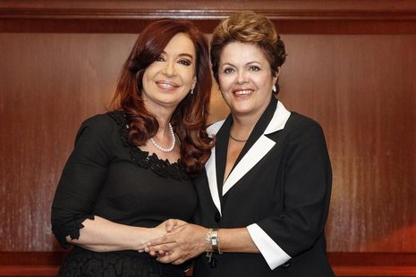 Brazil's President Dilma Rousseff (R) shakes hands with her Argentinean counterpart Cristina Fernandez de Kirchner during a meeting in Santi Brazil's President Dilma Rousseff (R) shakes hands with her Argentinean counterpart Cristina Fernandez de Kirchner during a meeting in Santi