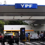 People walk past a YPF petrol station in Buenos Aires November 26, 2013. REUTERS/Marcos Brindicci People walk past a YPF petrol station in Buenos Aires November 26, 2013. REUTERS/Marcos Brindicci