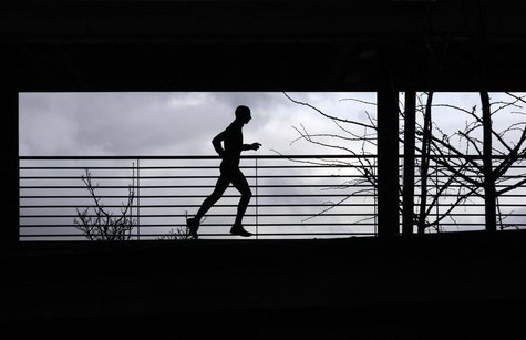 A man runs at the Athletic stadium in Florence February 16, 2011. REUTERS/Alessandro Bianchi A man runs at the Athletic stadium in Florence February 16, 2011. REUTERS/Alessandro Bianchi