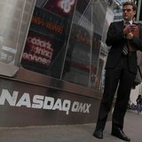 A man stands next to the Nasdaq MarketSite in New York, August 23, 2013. REUTERS/Brendan McDermid A man stands next to the Nasdaq MarketSite in New York, August 23, 2013. REUTERS/Brendan McDermid