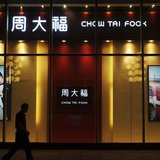 A man walks past a Chow Tai Fook shop in Yichang, Hubei province, September 3, 2013. REUTERS/China Daily A man walks past a Chow Tai Fook shop in Yichang, Hubei province, September 3, 2013. REUTERS/China Daily