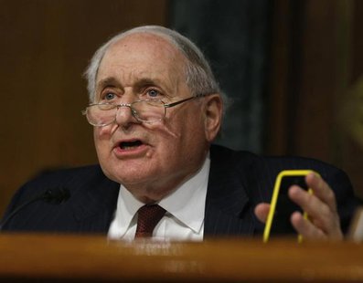 Senate homeland security and governmental affairs investigations subcommittee Chairman Carl Levin (D-MI) holds an iPhone as he speaks to App Senate homeland security and governmental affairs investigations subcommittee Chairman Carl Levin (D-MI) holds an iPhone as he speaks to App