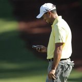 Tiger Woods of the U.S. looks at his iPhone after using it to take a picture of playing partner Mark O'Meara on the 10th green, during a pra Tiger Woods of the U.S. looks at his iPhone after using it to take a picture of playing partner Mark O'Meara on the 10th green, during a pra
