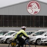 A cyclist rides past a General Motors (GM) Holden storage facility in Melbourne June 2, 2009. REUTERS/Mick Tsikas A cyclist rides past a General Motors (GM) Holden storage facility in Melbourne June 2, 2009. REUTERS/Mick Tsikas