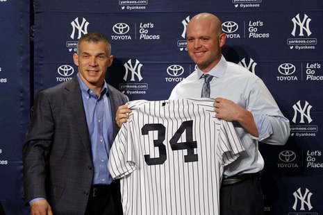 Dec 5, 2013; Bronx, NY, USA; New York Yankees manager Joe Girardi (right) and new catcher Brian McCann during press conference at Yankees St Dec 5, 2013; Bronx, NY, USA; New York Yankees manager Joe Girardi (right) and new catcher Brian McCann during press conference at Yankees St