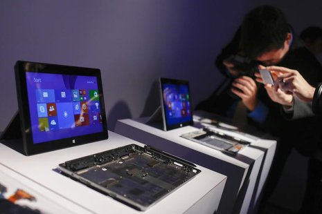 Members of the media take pictures of Surface 2 tablets during the launch of the Microsoft Surface 2 tablets in New York September 23, 2013. Members of the media take pictures of Surface 2 tablets during the launch of the Microsoft Surface 2 tablets in New York September 23, 2013.