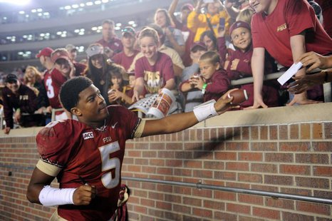 Nov 23, 2013; Tallahassee, FL, USA; Florida State Seminoles quarterback Jameis Winston (5) signs autographs for fans after the game against Nov 23, 2013; Tallahassee, FL, USA; Florida State Seminoles quarterback Jameis Winston (5) signs autographs for fans after the game against