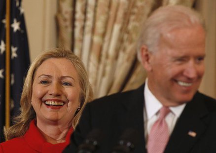 U.S. Secretary of State Hillary Clinton (L) listens to U.S. Vice President Joseph Biden during a luncheon for China's Vice President Xi Jinp U.S. Secretary of State Hillary Clinton (L) listens to U.S. Vice President Joseph Biden during a luncheon for China's Vice President Xi Jinp