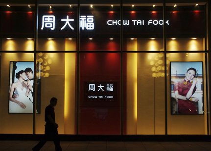A man walks past a Chow Tai Fook shop in Yichang, Hubei province, September 3, 2013. REUTERS/China Daily A man walks past a Chow Tai Fook shop in Yichang, Hubei province, September 3, 2013. REUTERS/China Daily