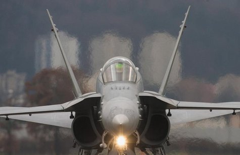 A Swiss Boeing F/A-18C rolls along the taxiway at the Swiss Army Airbase in Emmen, central Switzerland November 14, 2008. REUTERS/Michael Bu A Swiss Boeing F/A-18C rolls along the taxiway at the Swiss Army Airbase in Emmen, central Switzerland November 14, 2008. REUTERS/Michael Bu