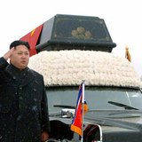 North Korea's new leader Kim Jong-un (2nd L) salutes as he and his uncle Jang Song-thaek (L) accompany the hearse carrying the coffin of lat North Korea's new leader Kim Jong-un (2nd L) salutes as he and his uncle Jang Song-thaek (L) accompany the hearse carrying the coffin of lat