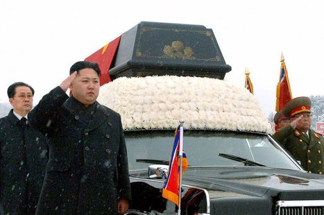 North Korea's new leader Kim Jong-un (2nd L) salutes as he and his uncle Jang Song-thaek (L) accompany the hearse carrying the coffin of lat North Korea's new leader Kim Jong-un (2nd L) salutes as he and his uncle Jang Song-thaek (L) accompany the hearse carrying the coffin of lat