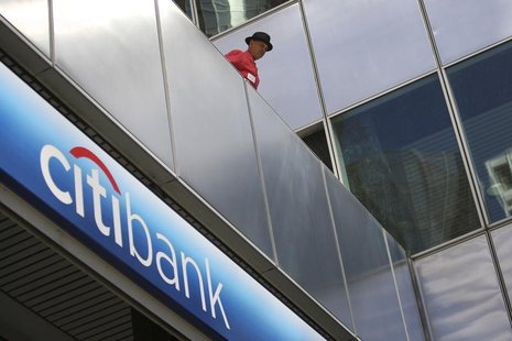 A man watches police officers make arrests as protesters from political activist group 99 Rise stage a sit-in at the entrance of a CitiBank A man watches police officers make arrests as protesters from political activist group 99 Rise stage a sit-in at the entrance of a CitiBank