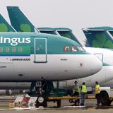 Ground crew are seen parking an Aer Lingus Airbus A320 away from the passenger terminals at Dublin Airport, in the Republic of Ireland in th Ground crew are seen parking an Aer Lingus Airbus A320 away from the passenger terminals at Dublin Airport, in the Republic of Ireland in th
