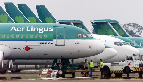 Ground crew are seen parking an Aer Lingus Airbus A320 away from the passenger terminals at Dublin Airport, in the Republic of Ireland in th Ground crew are seen parking an Aer Lingus Airbus A320 away from the passenger terminals at Dublin Airport, in the Republic of Ireland in th