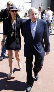 Former Ferrari team manager and FIA President Jean Todt and his girlfriend Michelle Yeoh walk in the paddock area before the Monaco F1 Grand Former Ferrari team manager and FIA President Jean Todt and his girlfriend Michelle Yeoh walk in the paddock area before the Monaco F1 Grand