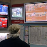 A man watches television screens in a Ladbrokes bookmaker in London February 19, 2009. REUTERS/Luke MacGregor A man watches television screens in a Ladbrokes bookmaker in London February 19, 2009. REUTERS/Luke MacGregor