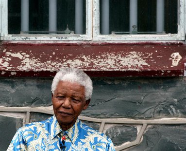 Nelson Mandela sits beneath the window of his prison cell on Robben Island near Cape Town, November 28, 2003. REUTERS/Mike Hutchings Nelson Mandela sits beneath the window of his prison cell on Robben Island near Cape Town, November 28, 2003. REUTERS/Mike Hutchings