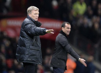 Manchester United manager David Moyes (L) and Everton manager Roberto Martinez direct their teams during their English Premier League soccer Manchester United manager David Moyes (L) and Everton manager Roberto Martinez direct their teams during their English Premier League soccer