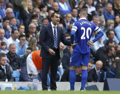 Everton's manager Roberto Martinez (L) talks with Ross Barkley during their English Premier League soccer match against Manchester City at t Everton's manager Roberto Martinez (L) talks with Ross Barkley during their English Premier League soccer match against Manchester City at t