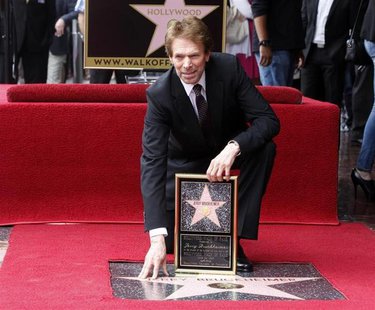 Film and television producer Jerry Bruckheimer poses with his star on the Hollywood Walk of Fame in Hollywood June 24, 2013. REUTERS/Fred Pr Film and television producer Jerry Bruckheimer poses with his star on the Hollywood Walk of Fame in Hollywood June 24, 2013. REUTERS/Fred Pr