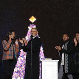 U.S. President Barack Obama applauds as he is joined by daughters Malia (L) and Sasha and First Lady Michelle Obama, after lighting the Nati U.S. President Barack Obama applauds as he is joined by daughters Malia (L) and Sasha and First Lady Michelle Obama, after lighting the Nati