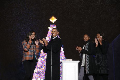 U.S. President Barack Obama applauds as he is joined by daughters Malia (L) and Sasha and First Lady Michelle Obama, after lighting the Nati U.S. President Barack Obama applauds as he is joined by daughters Malia (L) and Sasha and First Lady Michelle Obama, after lighting the Nati