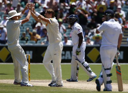 England's Michael Carberry (2nd R) walks off the field after his dismissal, as Australia's Shane Watson (2nd L) and Ryan Harris (L) celebrat England's Michael Carberry (2nd R) walks off the field after his dismissal, as Australia's Shane Watson (2nd L) and Ryan Harris (L) celebrat