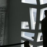 A U.S. Marine stands at attention at the "Remembrance Wall" in the Shrine Room on the USS Arizona Memorial during the 71st anniversary of th A U.S. Marine stands at attention at the "Remembrance Wall" in the Shrine Room on the USS Arizona Memorial during the 71st anniversary of th