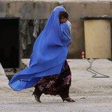 An Afghan woman wearing a burqa holds her child as she walks along a street on the outskirts of Kabul May 13, 2013. REUTERS/Omar Sobhani An Afghan woman wearing a burqa holds her child as she walks along a street on the outskirts of Kabul May 13, 2013. REUTERS/Omar Sobhani