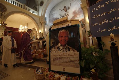A poster depicting former South African President Nelson Mandela is displayed during a special service in his honour at the Holy Family Chur A poster depicting former South African President Nelson Mandela is displayed during a special service in his honour at the Holy Family Chur