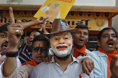 A supporter wearing a mask of Gujarat's chief minister and Hindu nationalist Narendra Modi, the prime ministerial candidate for India's main A supporter wearing a mask of Gujarat's chief minister and Hindu nationalist Narendra Modi, the prime ministerial candidate for India's main