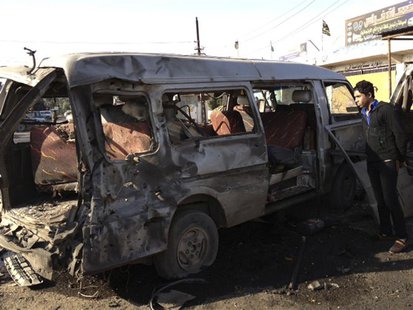 A man looks at a damaged vehicle after a car bomb attack at Bayaa district in Baghdad December 8, 2013. REUTERS/Ahmed Malik A man looks at a damaged vehicle after a car bomb attack at Bayaa district in Baghdad December 8, 2013. REUTERS/Ahmed Malik