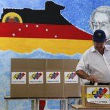 A man casts his ballot in a box during a municipal elections in Caracas December 8, 2013. REUTERS/Carlos Garcia Rawlins A man casts his ballot in a box during a municipal elections in Caracas December 8, 2013. REUTERS/Carlos Garcia Rawlins