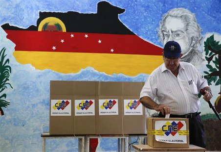 A man casts his ballot in a box during a municipal elections in Caracas December 8, 2013. REUTERS/Carlos Garcia Rawlins A man casts his ballot in a box during a municipal elections in Caracas December 8, 2013. REUTERS/Carlos Garcia Rawlins