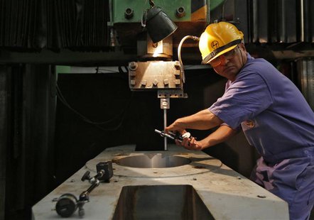 An employee works on the production line inside the heavy electrical manufacturing unit of Larsen & Turbo in Mumbai December 4, 2013. REUTER An employee works on the production line inside the heavy electrical manufacturing unit of Larsen & Turbo in Mumbai December 4, 2013. REUTER
