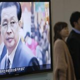 A couple walks past a television showing a report on Jang Song Thaek, North Korean leaders' uncle, at a railway station in Seoul December 3, A couple walks past a television showing a report on Jang Song Thaek, North Korean leaders' uncle, at a railway station in Seoul December 3,