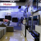 An employee arranges stools at a section displaying Haier television sets inside a Suning store in Shanghai August 26, 2013. REUTERS/Aly Son An employee arranges stools at a section displaying Haier television sets inside a Suning store in Shanghai August 26, 2013. REUTERS/Aly Son
