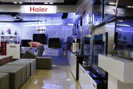 An employee arranges stools at a section displaying Haier television sets inside a Suning store in Shanghai August 26, 2013. REUTERS/Aly Son An employee arranges stools at a section displaying Haier television sets inside a Suning store in Shanghai August 26, 2013. REUTERS/Aly Son