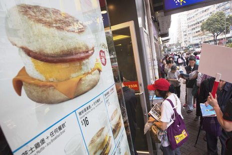 People queue for free offers McMuffin outside a McDonald's outlet at Sham Shui Po, one of the oldest districts in Hong Kong March 18, 2013. People queue for free offers McMuffin outside a McDonald's outlet at Sham Shui Po, one of the oldest districts in Hong Kong March 18, 2013.