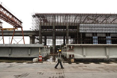 A man walks past a light rail station under construction at the Orile-Iganmu district in Lagos August 29, 2013. REUTERS/Akintunde Akinleye A man walks past a light rail station under construction at the Orile-Iganmu district in Lagos August 29, 2013. REUTERS/Akintunde Akinleye