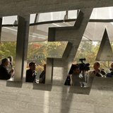 Journalists are reflected in a logo at the FIFA headquarters after a meeting of the executive committee in Zurich October 4, 2013. REUTERS/A Journalists are reflected in a logo at the FIFA headquarters after a meeting of the executive committee in Zurich October 4, 2013. REUTERS/A