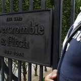 An employee stands outside the Champs Elysees store of clothing retailer Abercrombie & Fitch on opening day in Paris May 19, 2011. REUTERS/B An employee stands outside the Champs Elysees store of clothing retailer Abercrombie & Fitch on opening day in Paris May 19, 2011. REUTERS/B