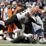 Dec 8, 2013; Foxborough, MA, USA; New England Patriots tight end Rob Gronkowski (87) is tackled by Cleveland Browns strong safety T.J. Ward Dec 8, 2013; Foxborough, MA, USA; New England Patriots tight end Rob Gronkowski (87) is tackled by Cleveland Browns strong safety T.J. Ward