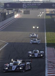 Race cars compete during the start of the final race of the 2013 World Endurance Championship (WEC) Six Hours of Bahrain at the Bahrain Inte Race cars compete during the start of the final race of the 2013 World Endurance Championship (WEC) Six Hours of Bahrain at the Bahrain Inte