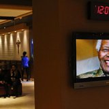 Nelson Mandela is pictured on a display screen as people attend a tribute service for him at the Christian Cultural Center in the Brooklyn a Nelson Mandela is pictured on a display screen as people attend a tribute service for him at the Christian Cultural Center in the Brooklyn a