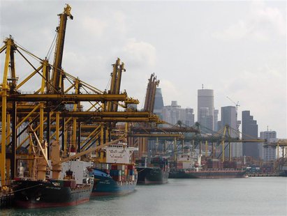 Container ships are seen berthed at the Brani container terminal near Singapore's financial district in this February 19, 2010 file photo. R Container ships are seen berthed at the Brani container terminal near Singapore's financial district in this February 19, 2010 file photo. R