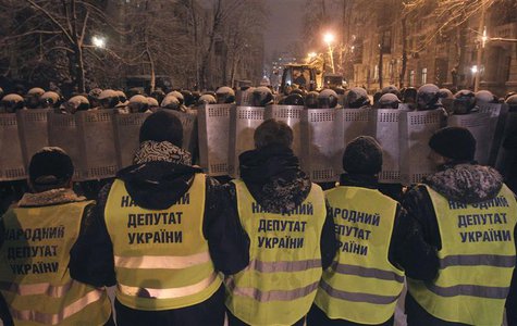 REFILE - ADDING ADDITIONAL INFORMATION Supporters of EU integration line up in front of riot police with shields during a rally in Kiev, Dec REFILE - ADDING ADDITIONAL INFORMATION Supporters of EU integration line up in front of riot police with shields during a rally in Kiev, Dec