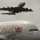 An Airbus A380 aircraft of Deutsche Lufthansa (top) takes of passing over an Airbus A380 aircraft of Emirates at the ILA International Air S An Airbus A380 aircraft of Deutsche Lufthansa (top) takes of passing over an Airbus A380 aircraft of Emirates at the ILA International Air S