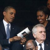 U.S. President Barack Obama (back L) and his wife, first lady Michelle Obama look at the official program booklet during the memorial servic U.S. President Barack Obama (back L) and his wife, first lady Michelle Obama look at the official program booklet during the memorial servic